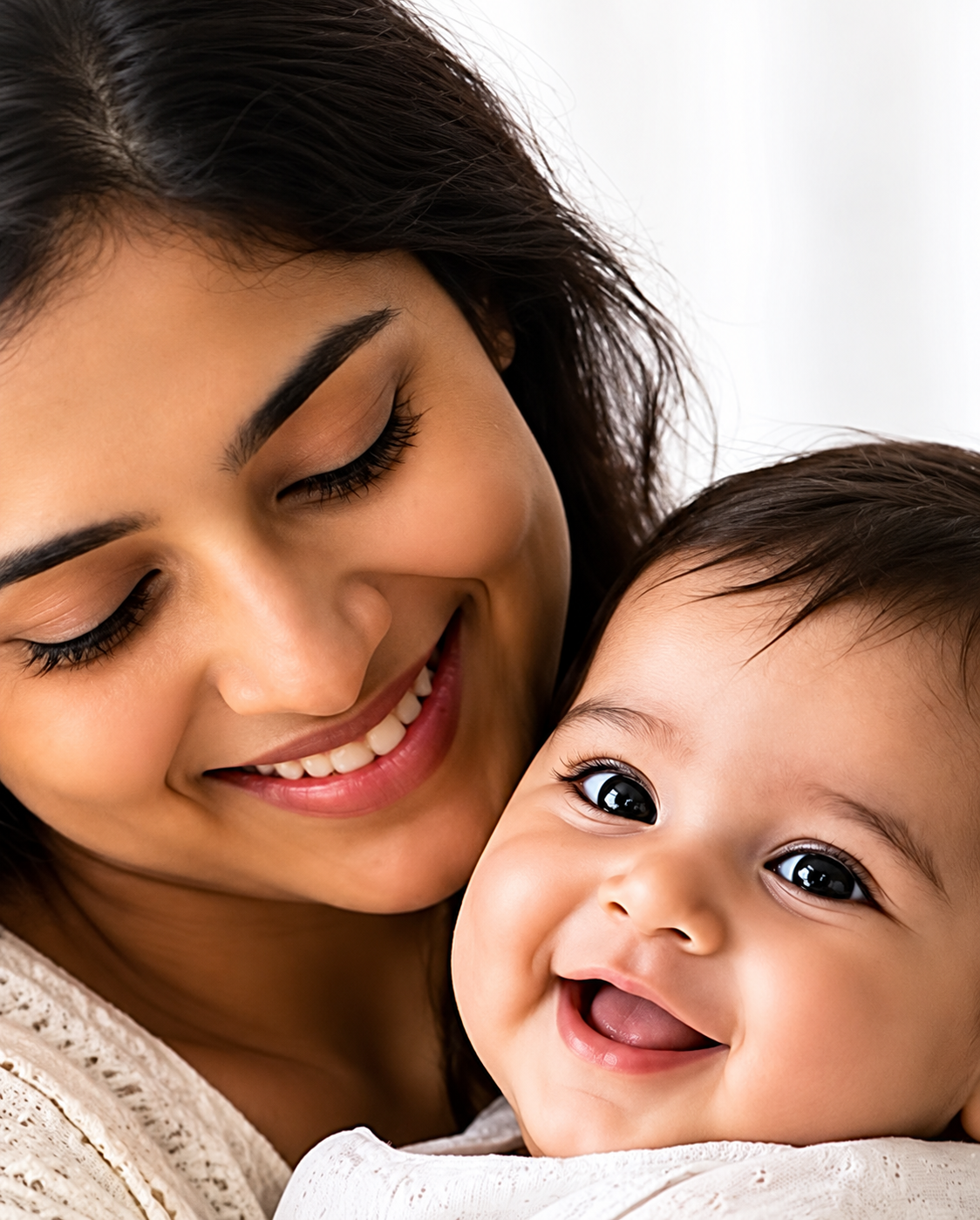 Smiling mother holding her happy baby